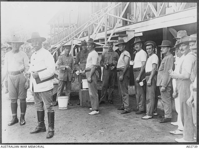 Men line up for their dose of quinine.